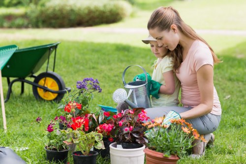Insured gardening team reviewing insurance documents on site